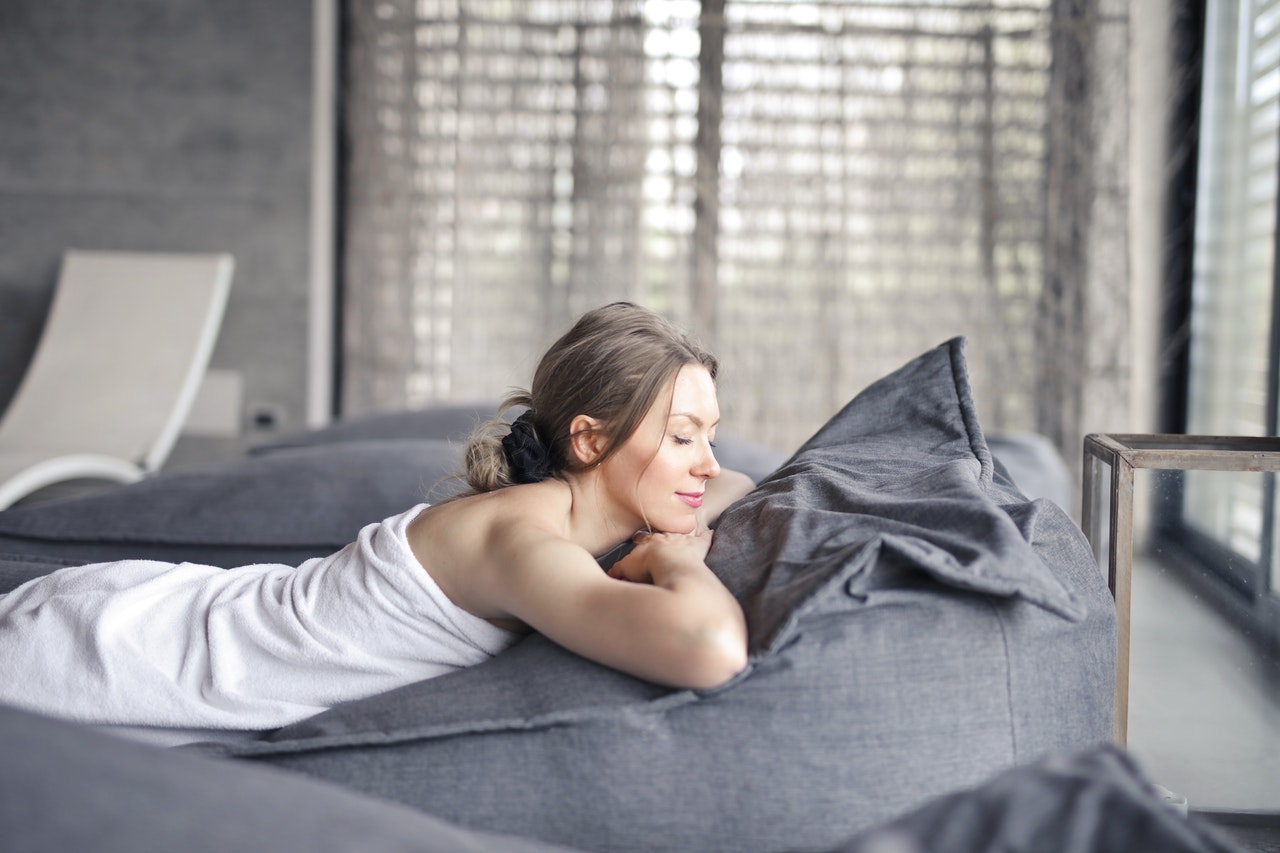 woman relaxing laying on bed