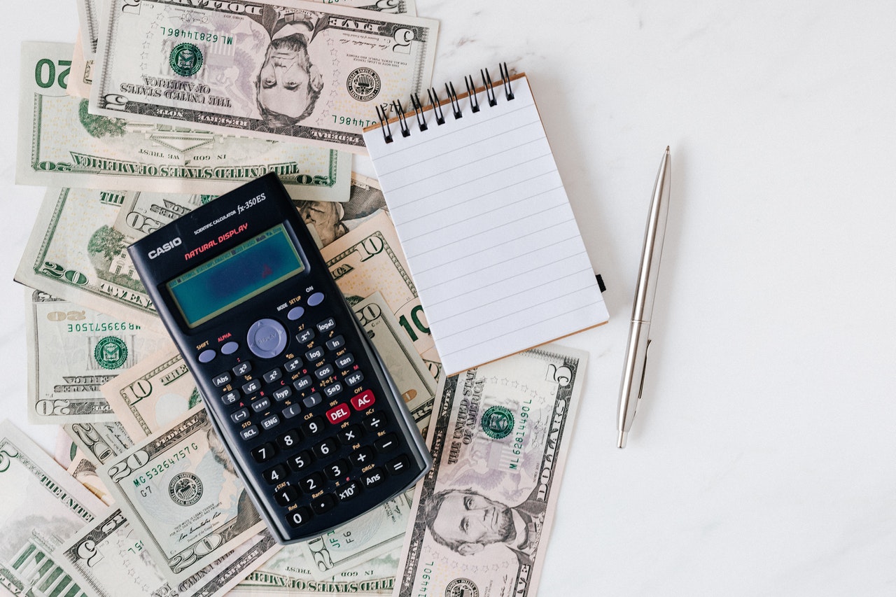 calculator cash and a notepad together