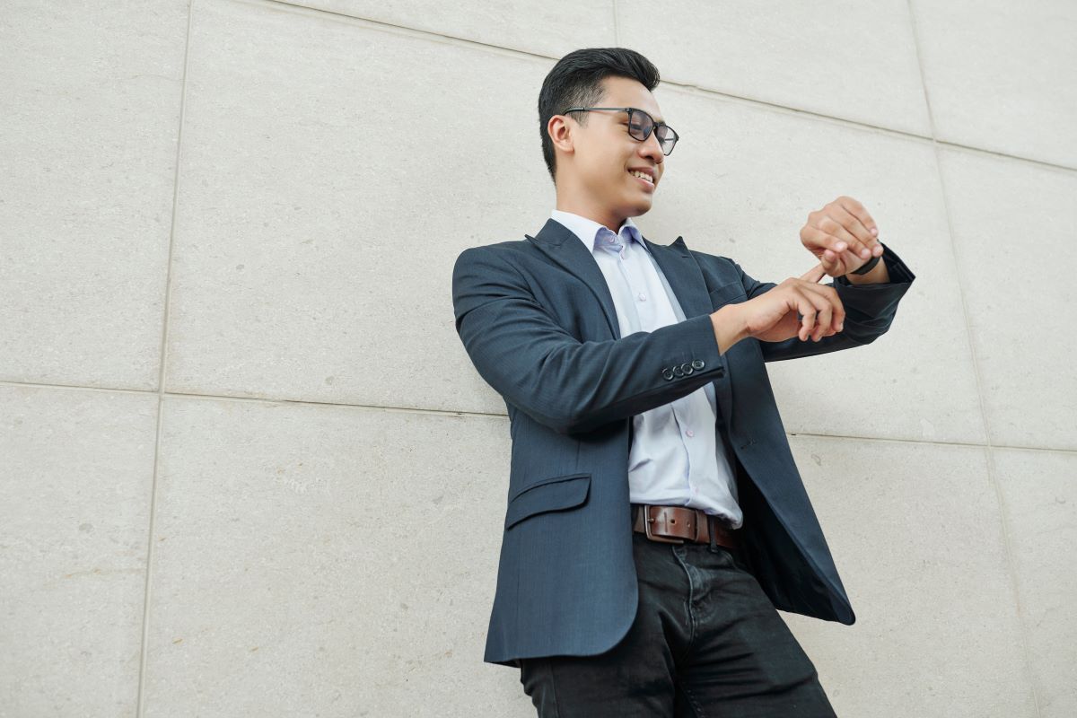 well dressed man pointing at his watch