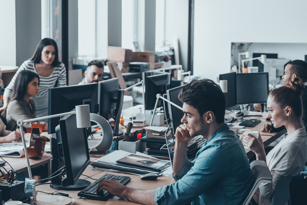 Company employees working together using their computers