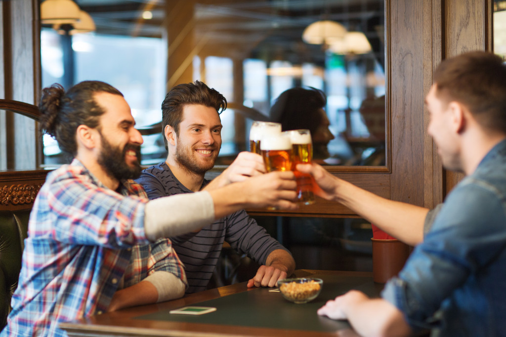 guy friends having beer together at restobar