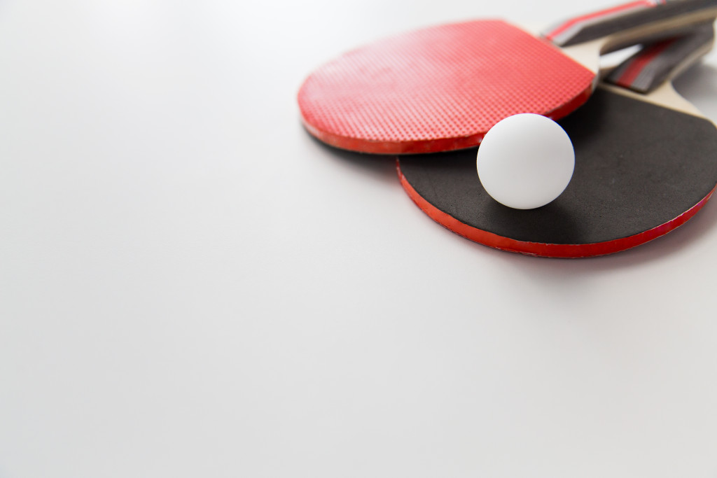 ping pong ball and racket on table