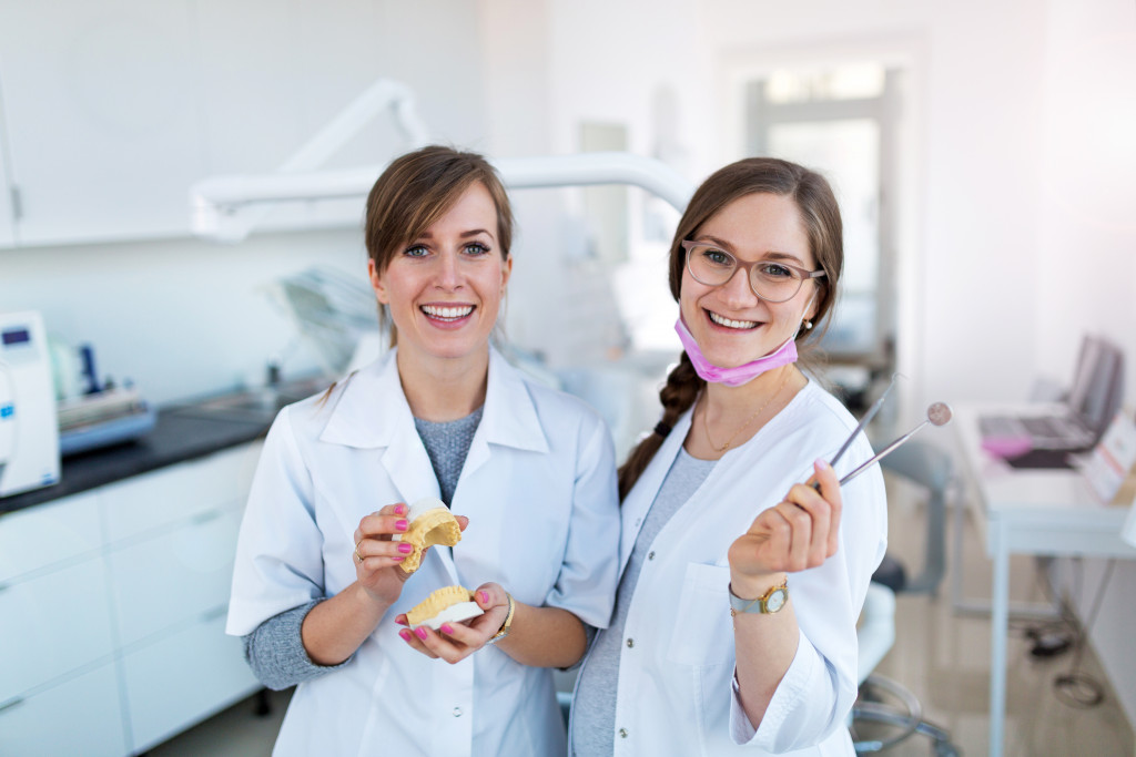 dental professionals holding modern tools
