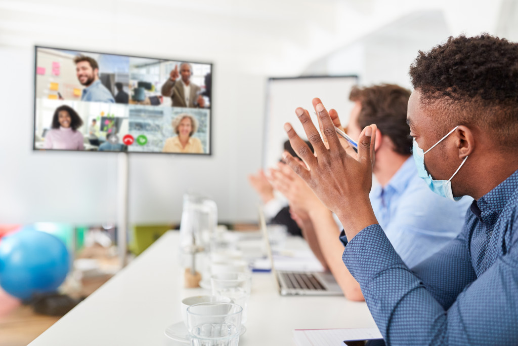 Employees attending a video conference at an office.