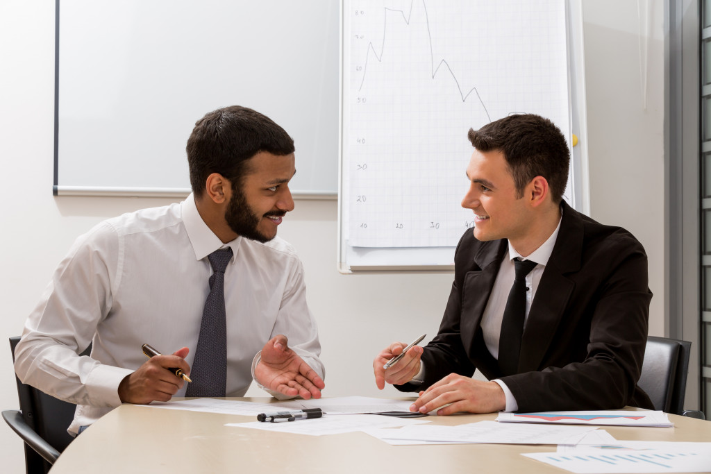 A businessman talking to a business coach in an office